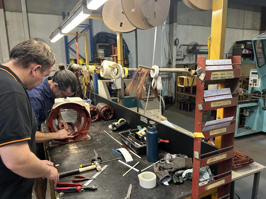 Technician inspecting an electric motor stator during a rewind in Perth
